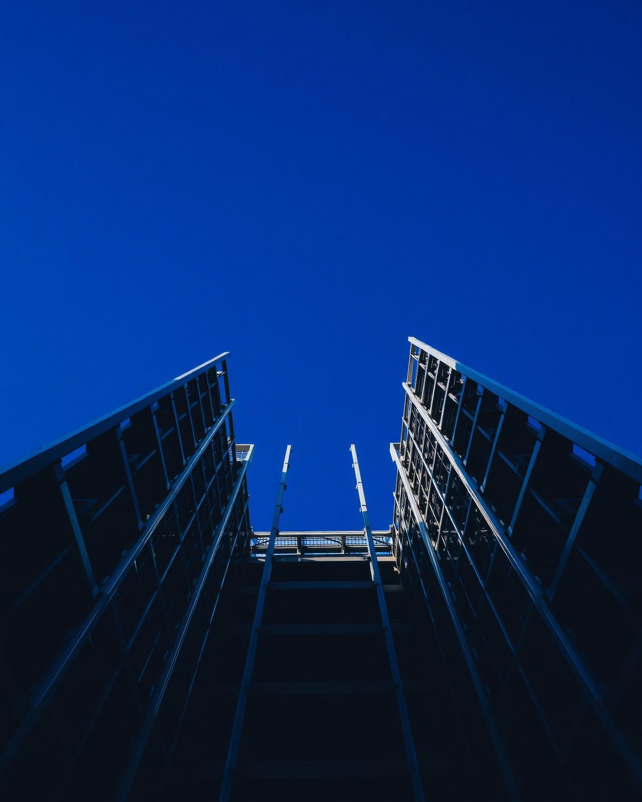 Glass towers rising against a blue sky